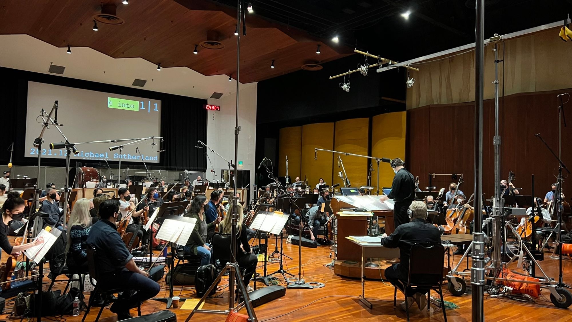 Michael Sutherland conducting an orchestra recording session